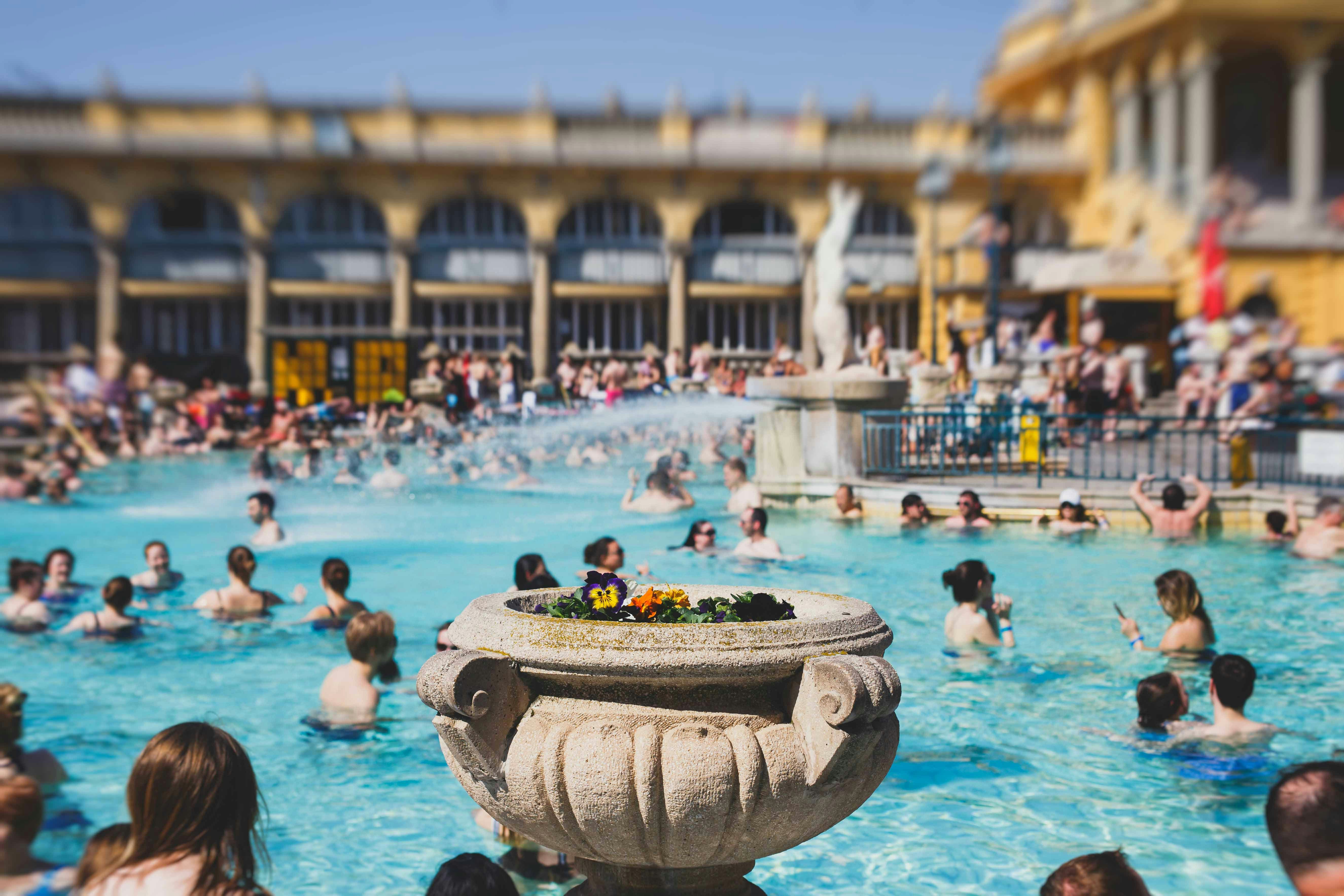 Széchenyi Baths outdoor thermal pools in Budapest, Hungary, with people enjoying the warm water.