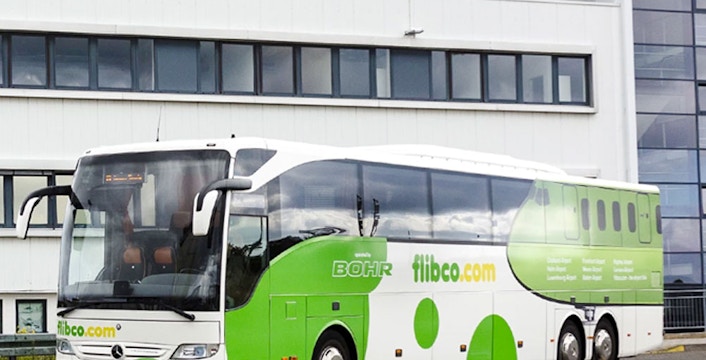 Flibco bus parked at Frankfurt Hahn Airport terminal.