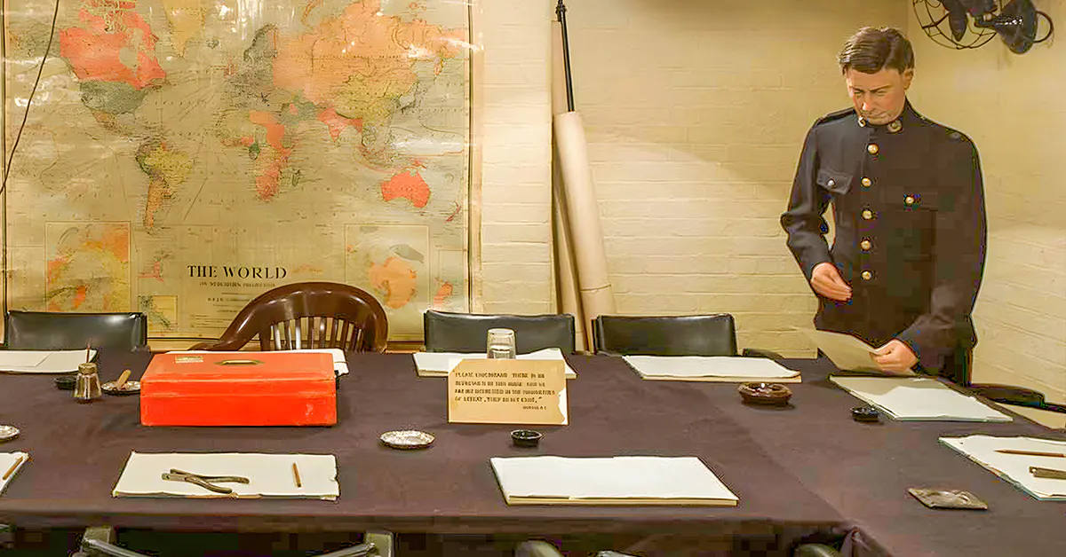 Meeting room in Churchill War Rooms with historical map and uniformed figure.