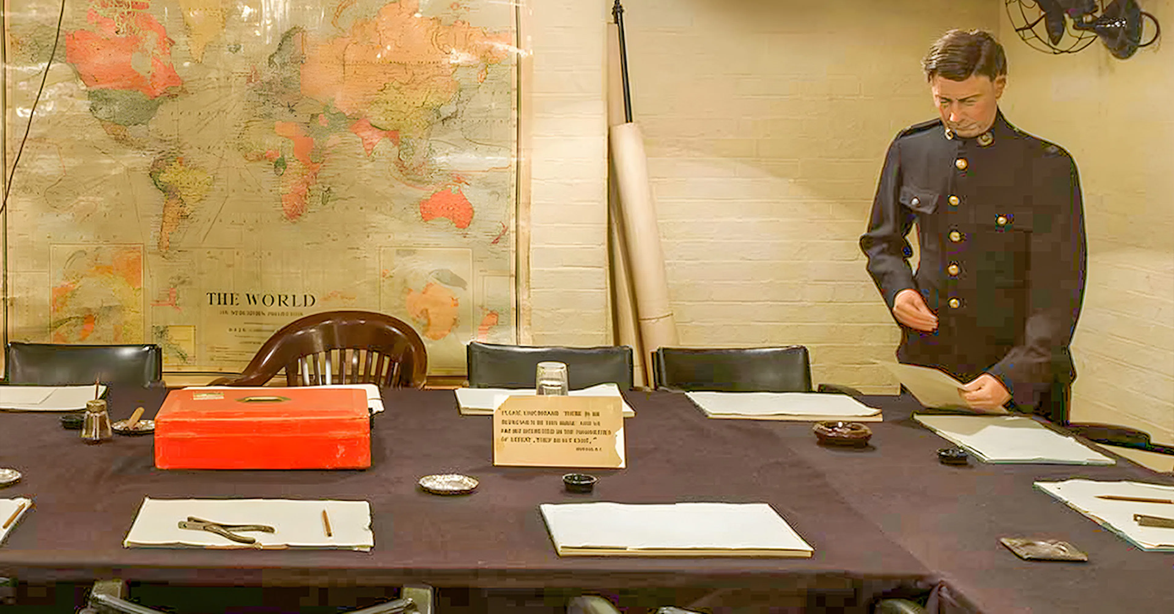 Meeting room in Churchill War Rooms with historical map and uniformed figure.