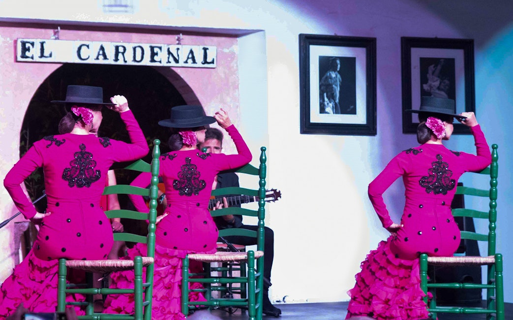 Flamenco dancers in pink dresses performing at Tablao Cardenal, Córdoba.