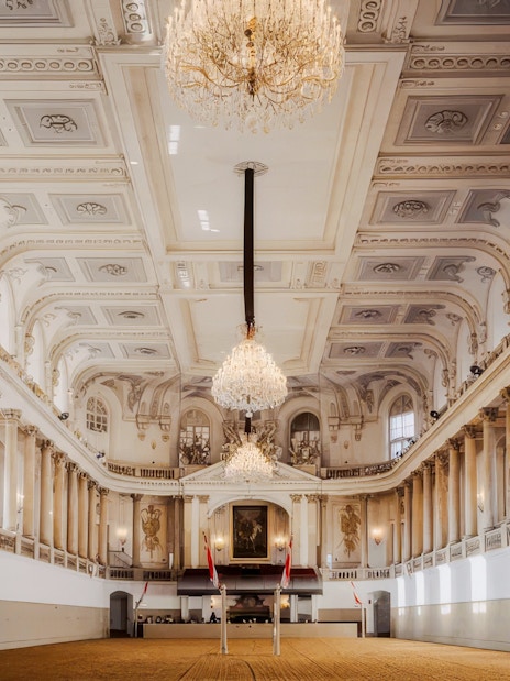 Winter Riding School's grand hall with ornate chandeliers and classical architecture in Vienna.
