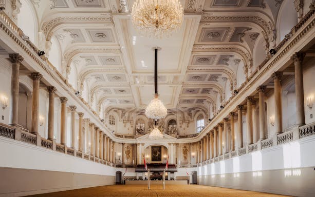 Winter Riding School's grand hall with ornate chandeliers and classical architecture in Vienna.