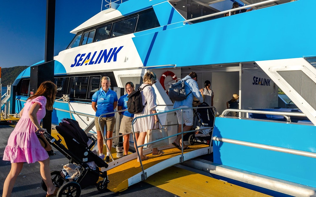 Tourists boarding a SeaLink ferry for the Hill Inlet Lookout and Whitehaven Beach cruise at Airlie Beach.