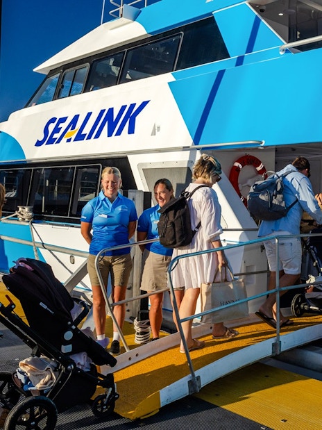 Tourists boarding a SeaLink ferry for the Hill Inlet Lookout and Whitehaven Beach cruise at Airlie Beach.