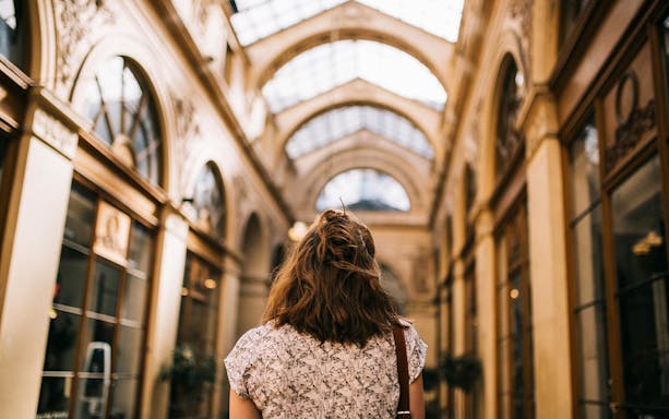 Walking through a covered passage in Paris during a guided tour.