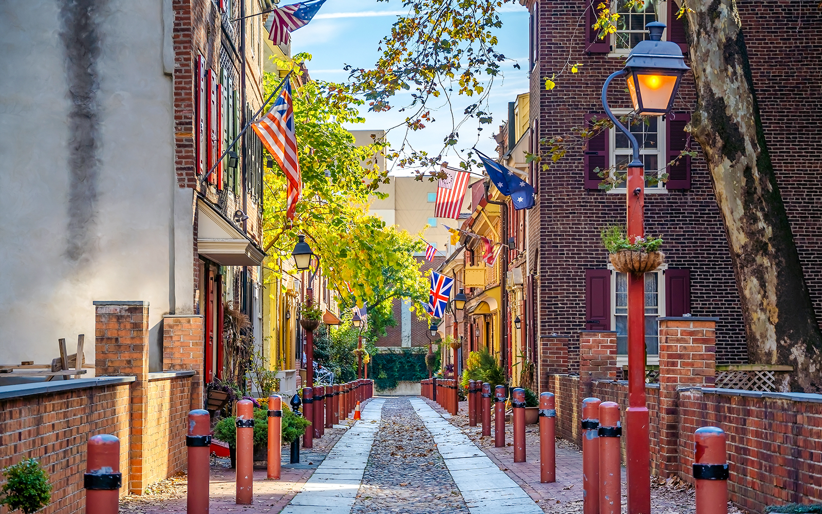 Elfreth's Alley in Philadelphia's historic Old City with flags and cobblestone path.