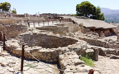 Phaistos Palace ruins with stone structures and pathways, Crete, Greece.