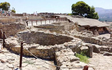 Phaistos Palace ruins with stone structures and pathways, Crete, Greece.