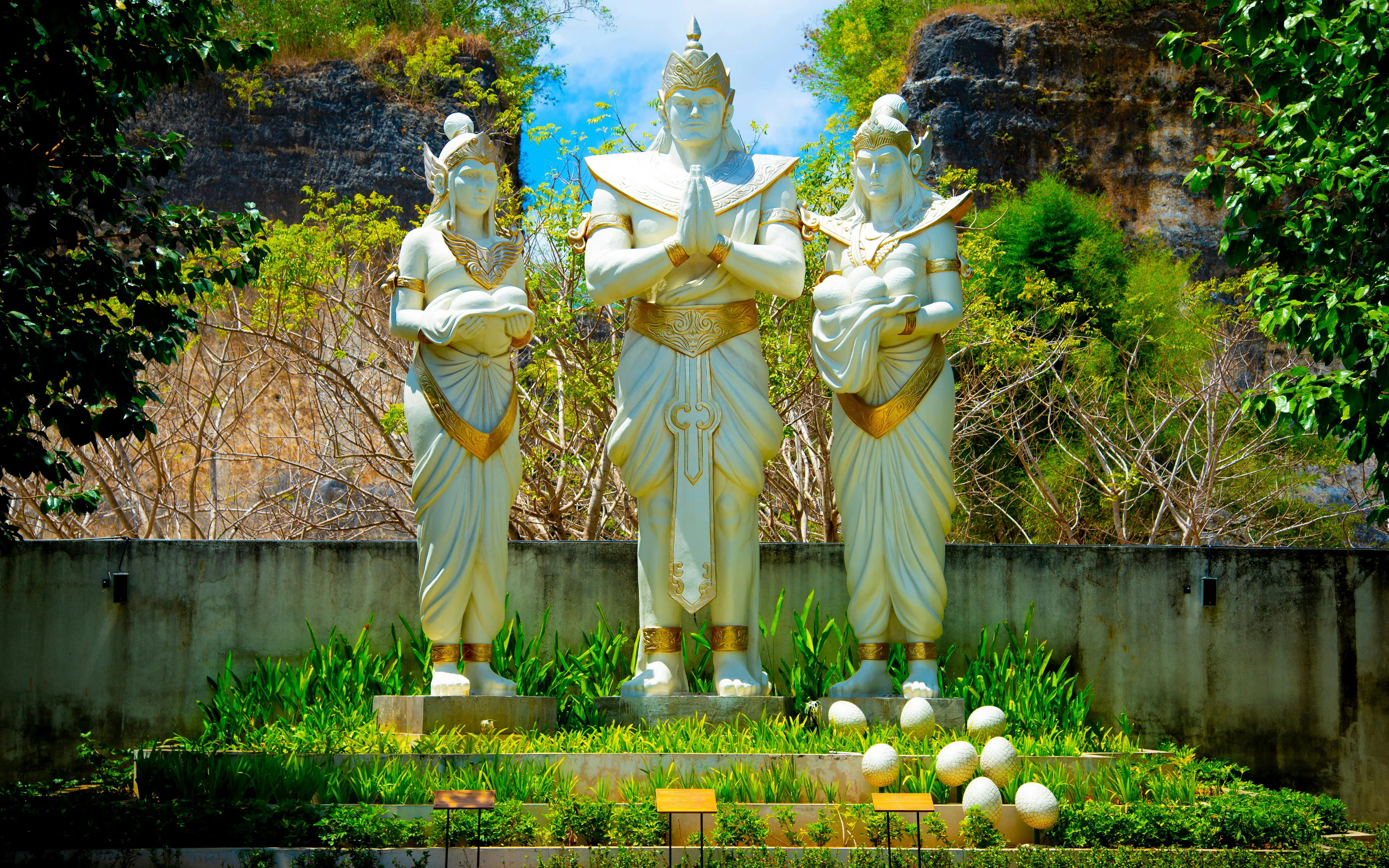 Plaza Bhagawan statues surrounded by greenery in Bali, Indonesia.