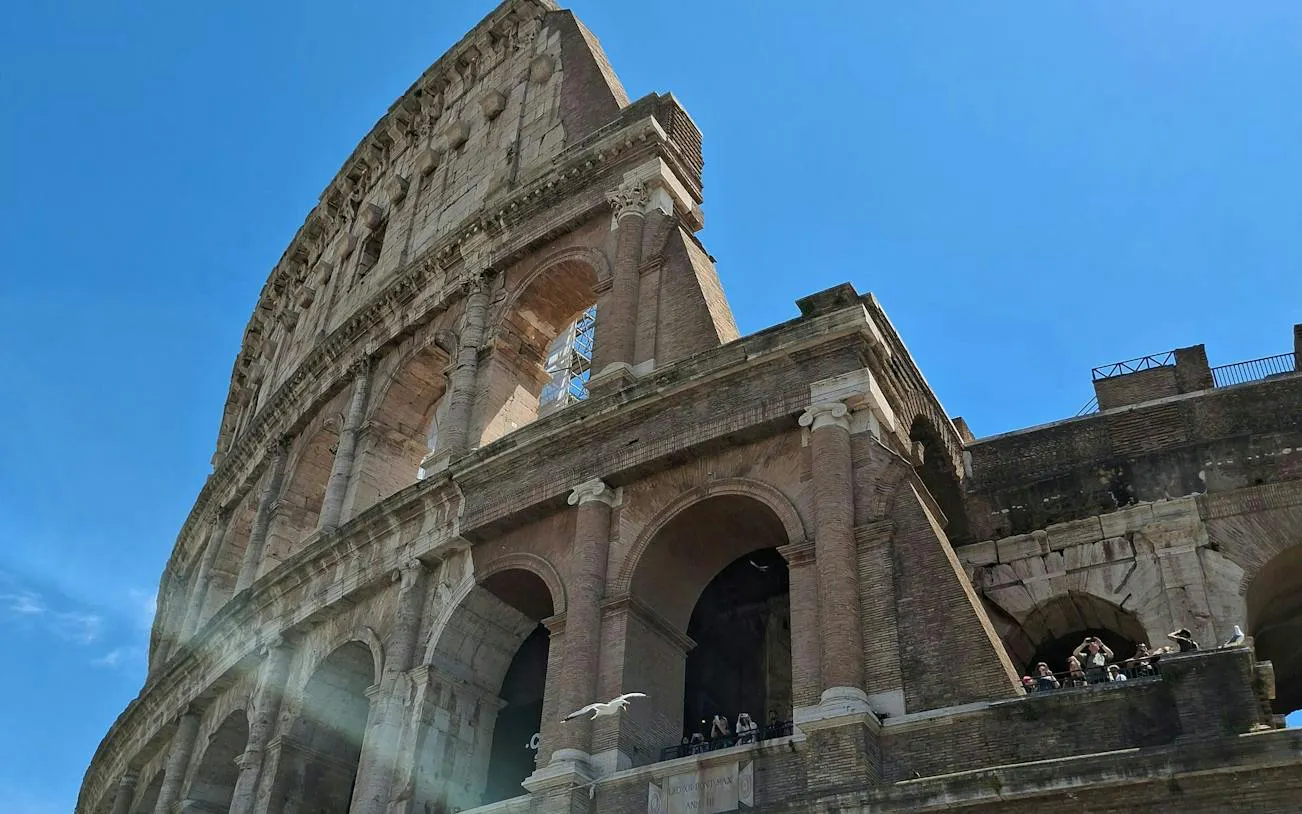 Colosseum exterior with tourists, Rome, for self-guided city exploration game.