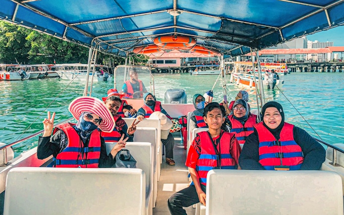Tourists on a boat ride during a multi-day tour of Mount Kinabalu and Kundasang.