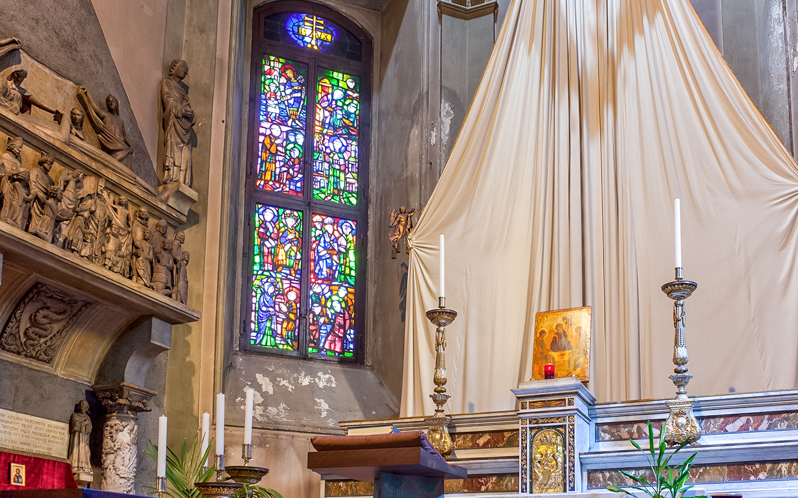 Stained glass window and altar inside Church of St. Gottard, Milan.