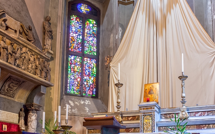 Stained glass window and altar inside Church of St. Gottard, Milan.