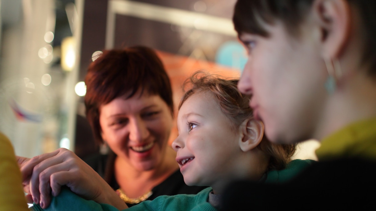 Family enjoying interactive exhibit in museum.