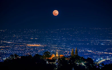 Lunar eclipse over Wat Phrathat Doi Suthep Temple, Chiang Mai, Thailand, 2020.