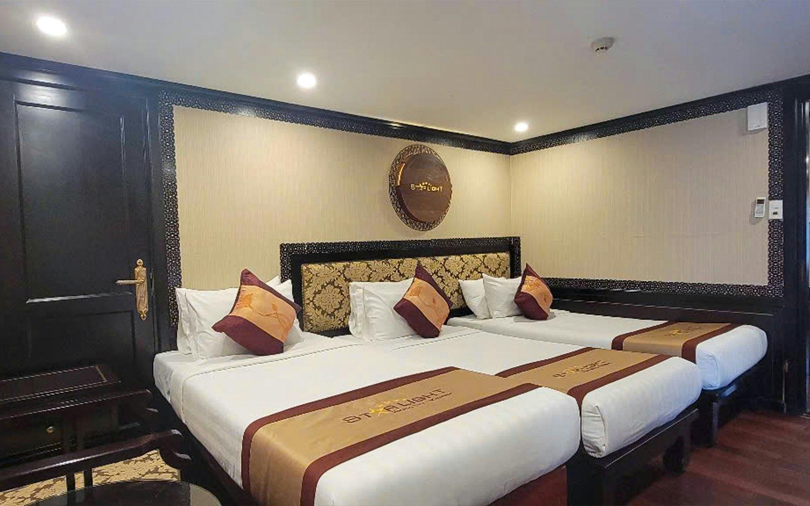 Luxurious cabin with twin beds on a 5-star cruise in Halong Bay.