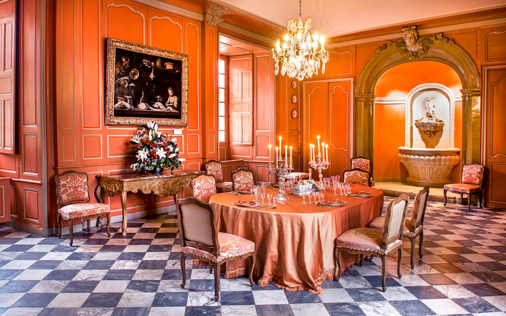 Dining room with ornate table setting inside Chateau de Villandry, France.