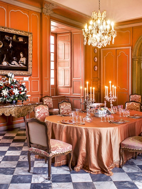 Dining room with ornate table setting inside Chateau de Villandry, France.