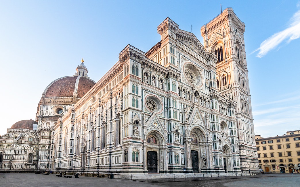 Florence Duomo with dome and bell tower under clear sky.