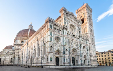 Florence Duomo with dome and bell tower under clear sky.