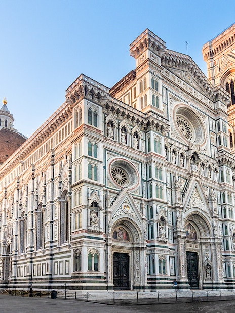 Florence Duomo with dome and bell tower under clear sky.