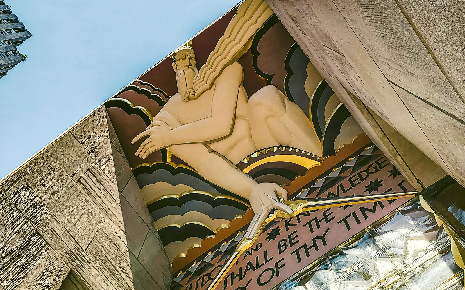 Low-angle view of the Prometheus statue mural at Rockefeller Center, New York City.