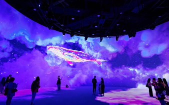 Immersive digital whale display at Kuala Lumpur exhibit with visitors observing.