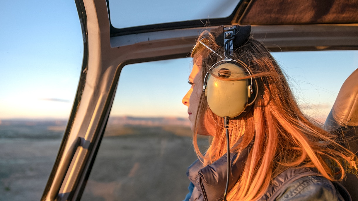 Helicopter flying over Grand Canyon with girl looking out window, Las Vegas tour.