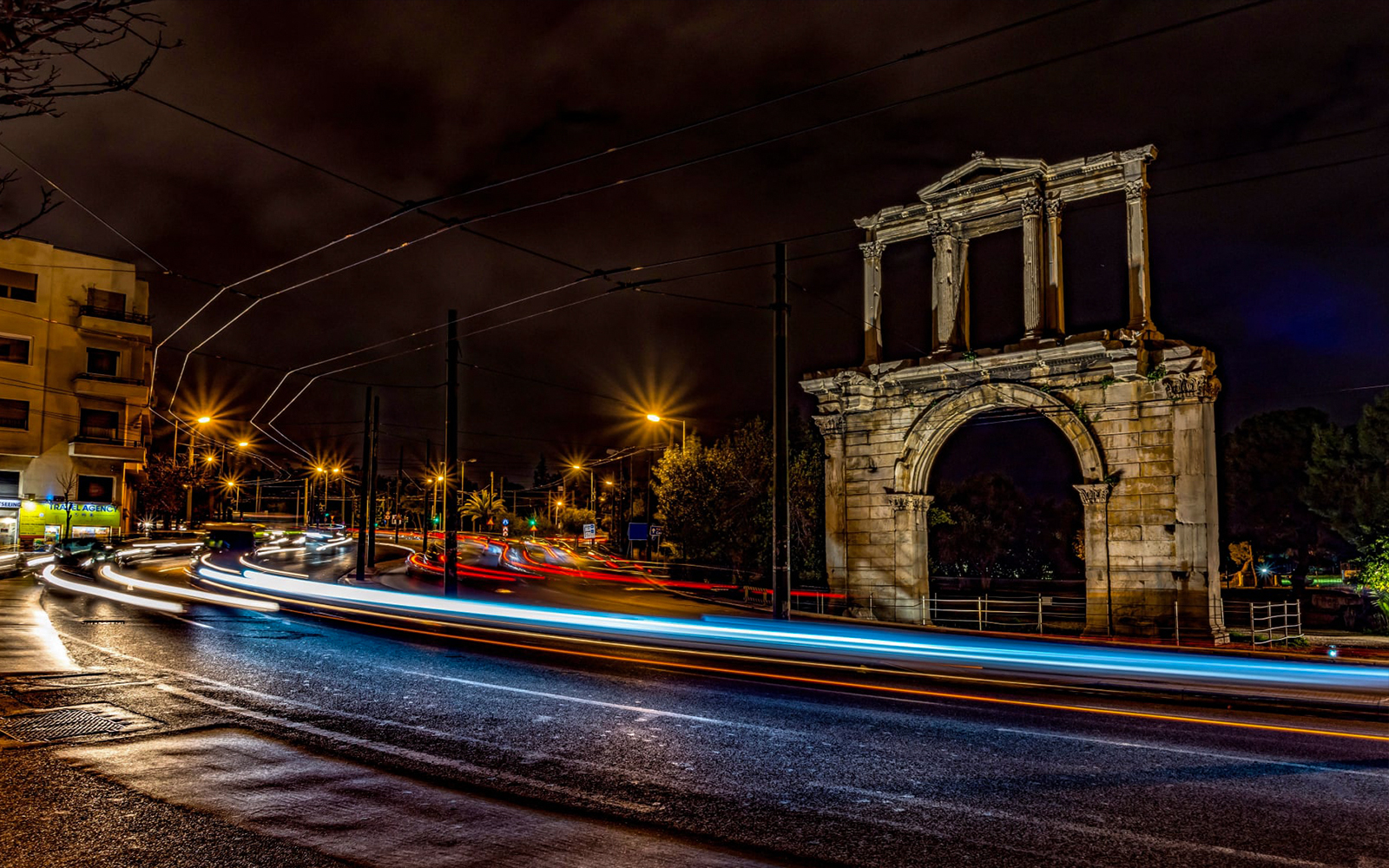 Hadrian's Arch illuminated at night during Athens bus tour.