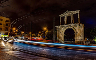 Hadrian's Arch illuminated at night during Athens bus tour.