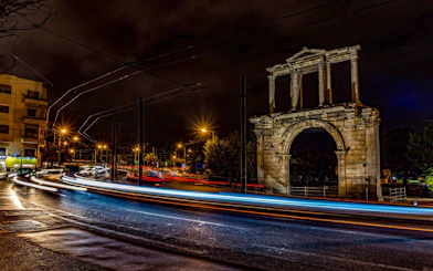 Hadrian's Arch illuminated at night during Athens bus tour.