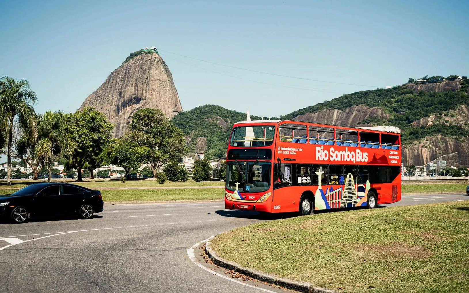 Rio Samba Bus in front of Sugarloaf Mountain, Rio de Janeiro, on a hop-on hop-off tour.