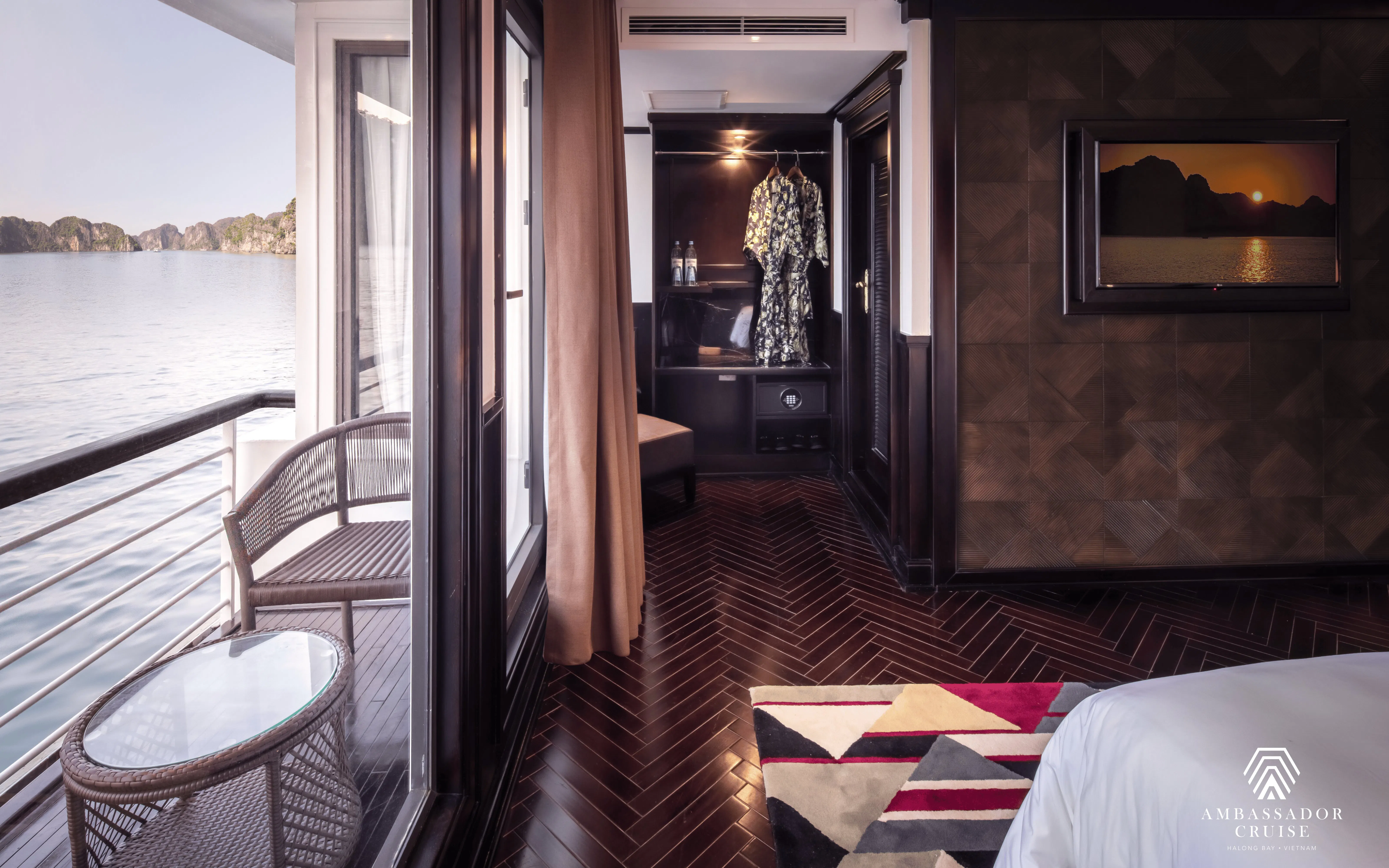 Luxurious cabin interior with balcony view on Ambassador Premium cruise in Halong Bay, Vietnam.