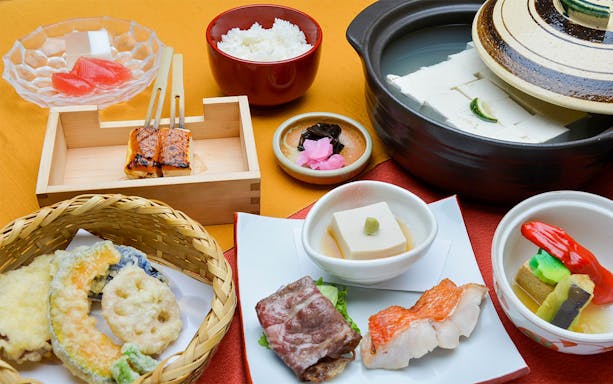Traditional Japanese meal with tofu, tempura, grilled fish, and rice on Kyoto Full-Day Tour.