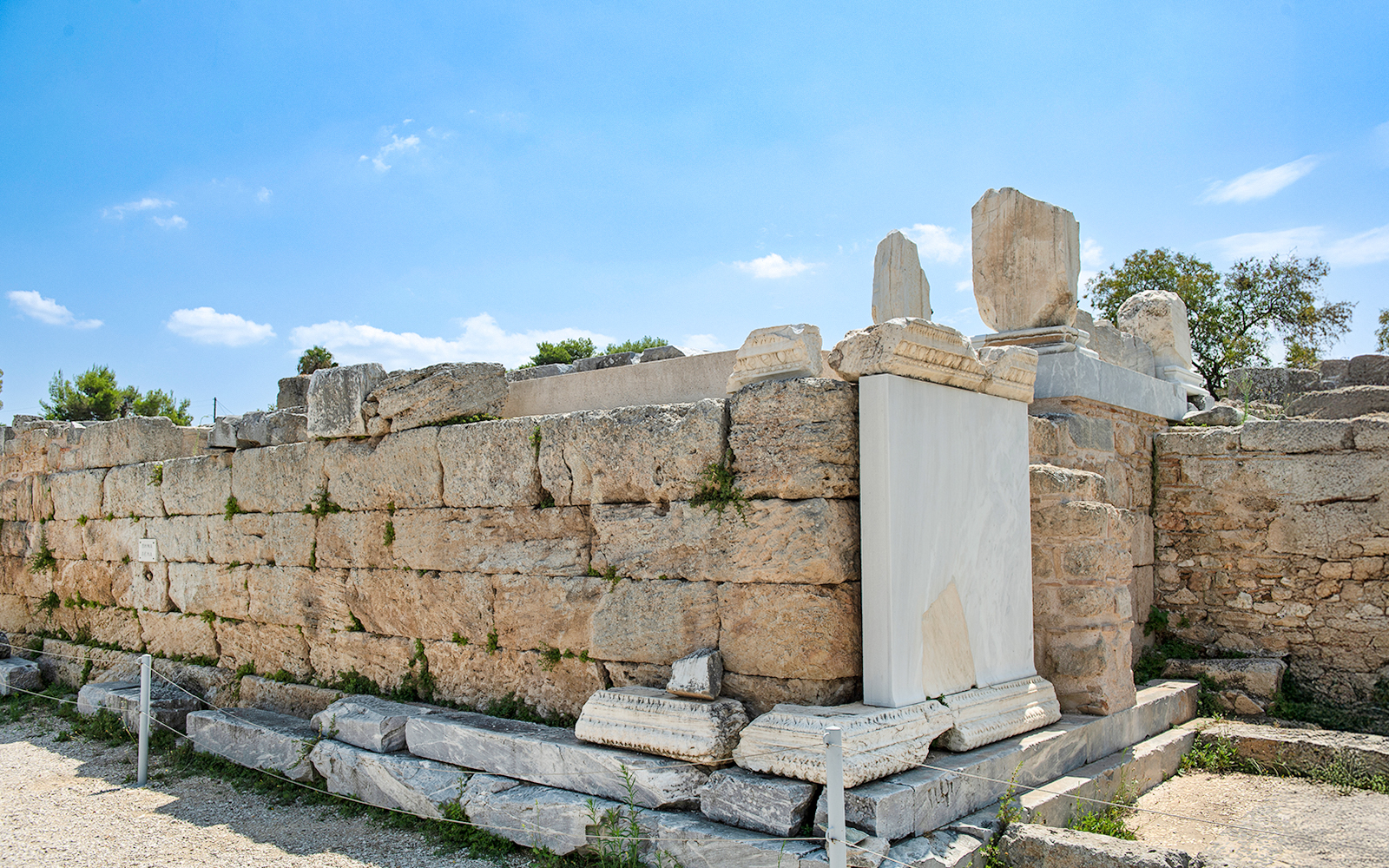 Ancient stone structure at Bema of Saint Paul, Greece, under a clear blue sky.