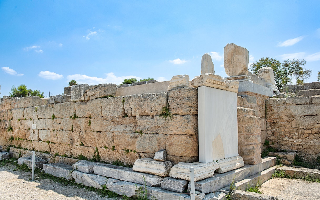 Ancient stone structure at Bema of Saint Paul, Greece, under a clear blue sky.