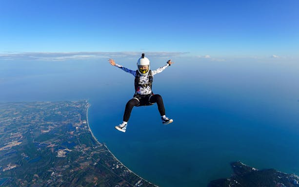 Skydiver over Pattaya coastline during Ocean View Tandem Skydive at 13,000 ft.