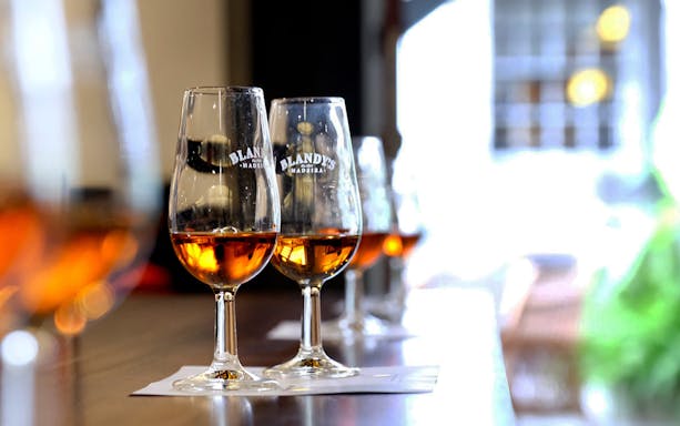 Wine glasses with Madeira wine at a tasting in Funchal, Portugal.