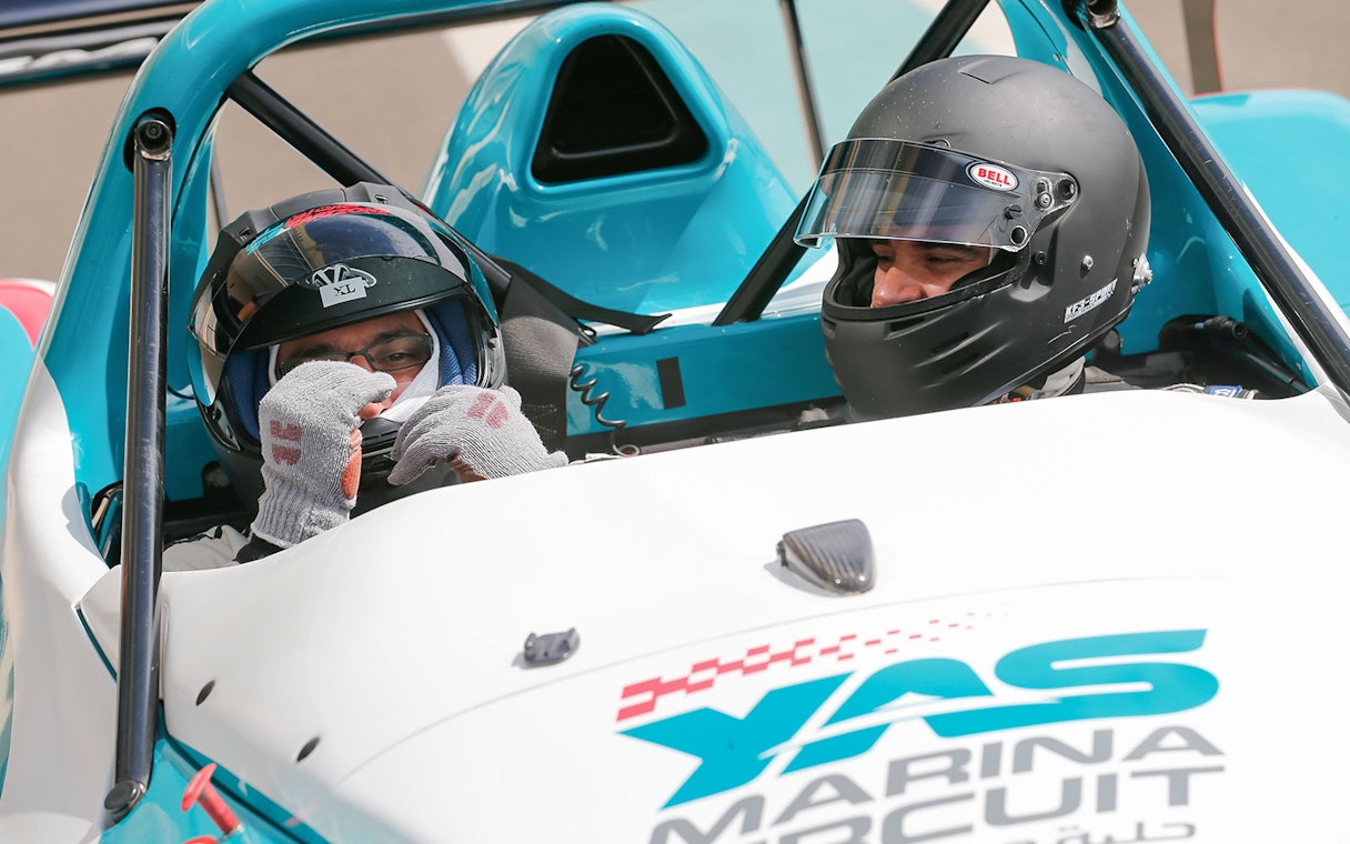 Two people in a race car at Yas Marina Circuit for YAS Radical SST Passenger experience.
