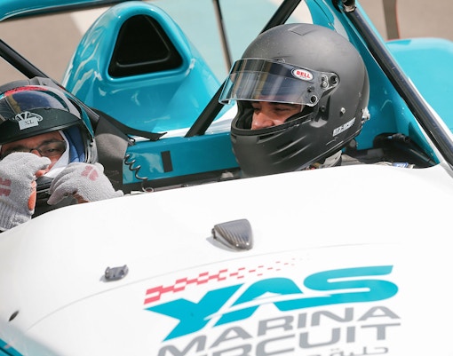 Two people in a race car at Yas Marina Circuit for YAS Radical SST Passenger experience.