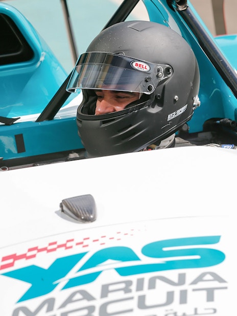 Two people in a race car at Yas Marina Circuit for YAS Radical SST Passenger experience.