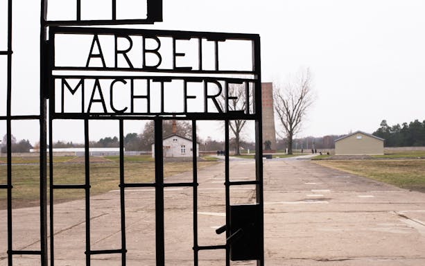 Entrance gate with "Arbeit Macht Frei" at Dachau Concentration Camp Memorial, Germany.