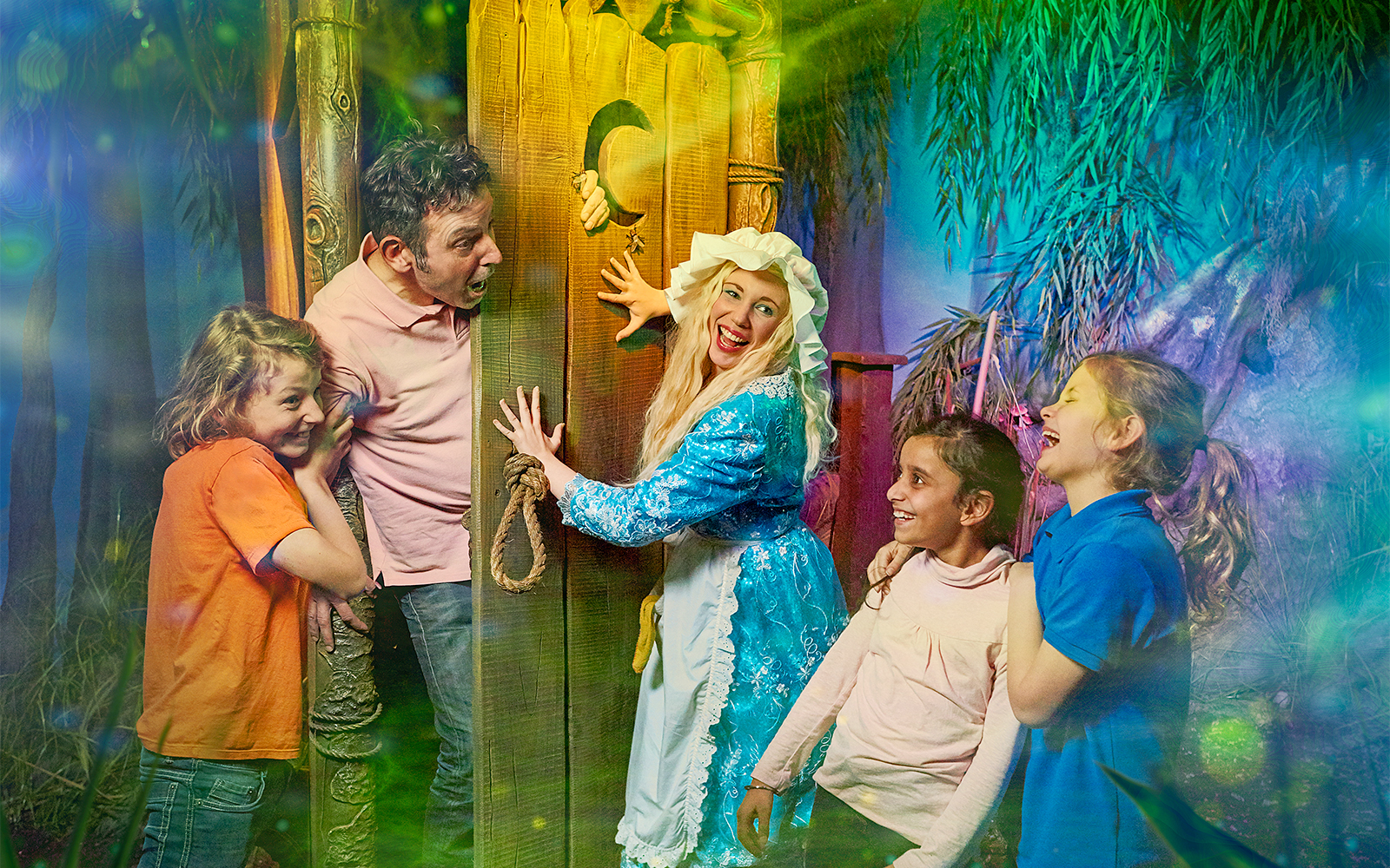 Visitors enjoying interactive scene at Shrek’s Adventure! London with a costumed character.