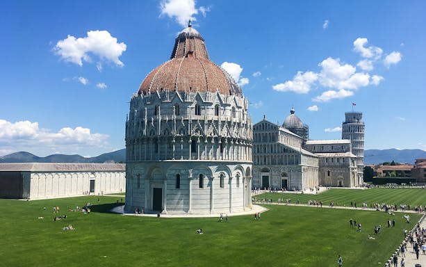 Baptistery, Cathedral, and Leaning Tower in Pisa on a sunny day.