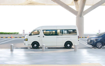 White minivan parked at Zanzibar airport for private transfer service.