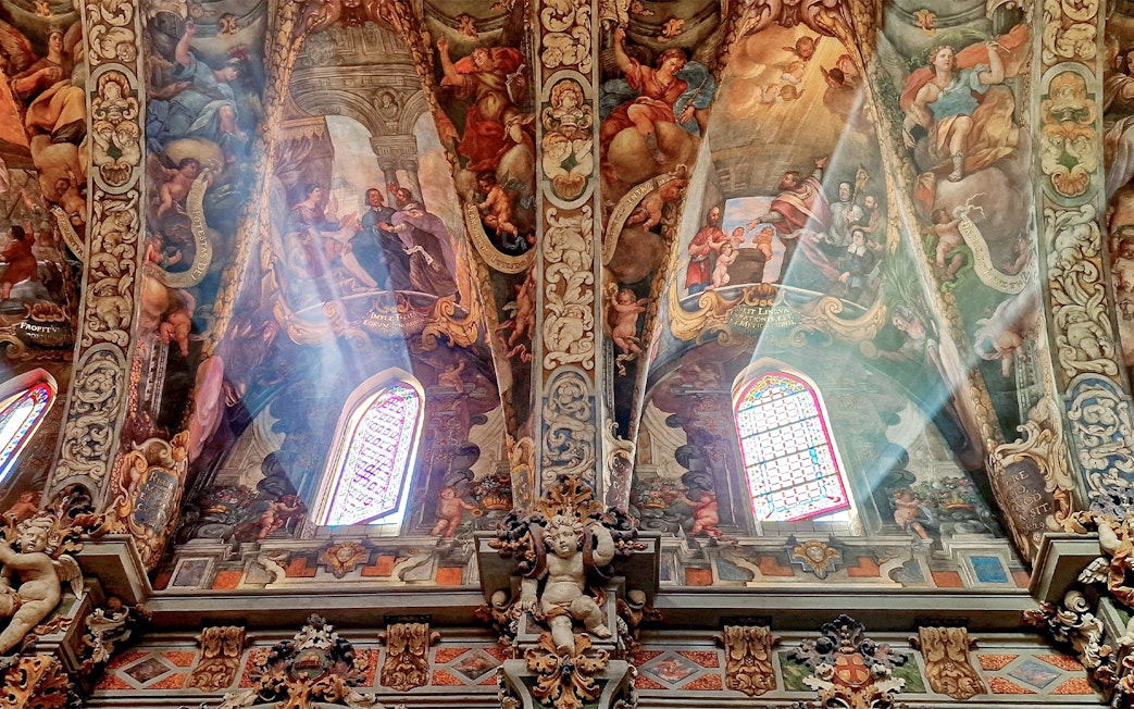 San Nicolas Church ceiling with detailed frescoes and stained glass windows in Valencia, Spain.