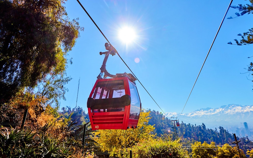 Santiago cable car with Andes mountains in the background.