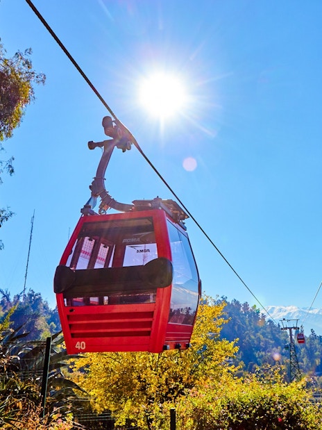 Santiago cable car with Andes mountains in the background.