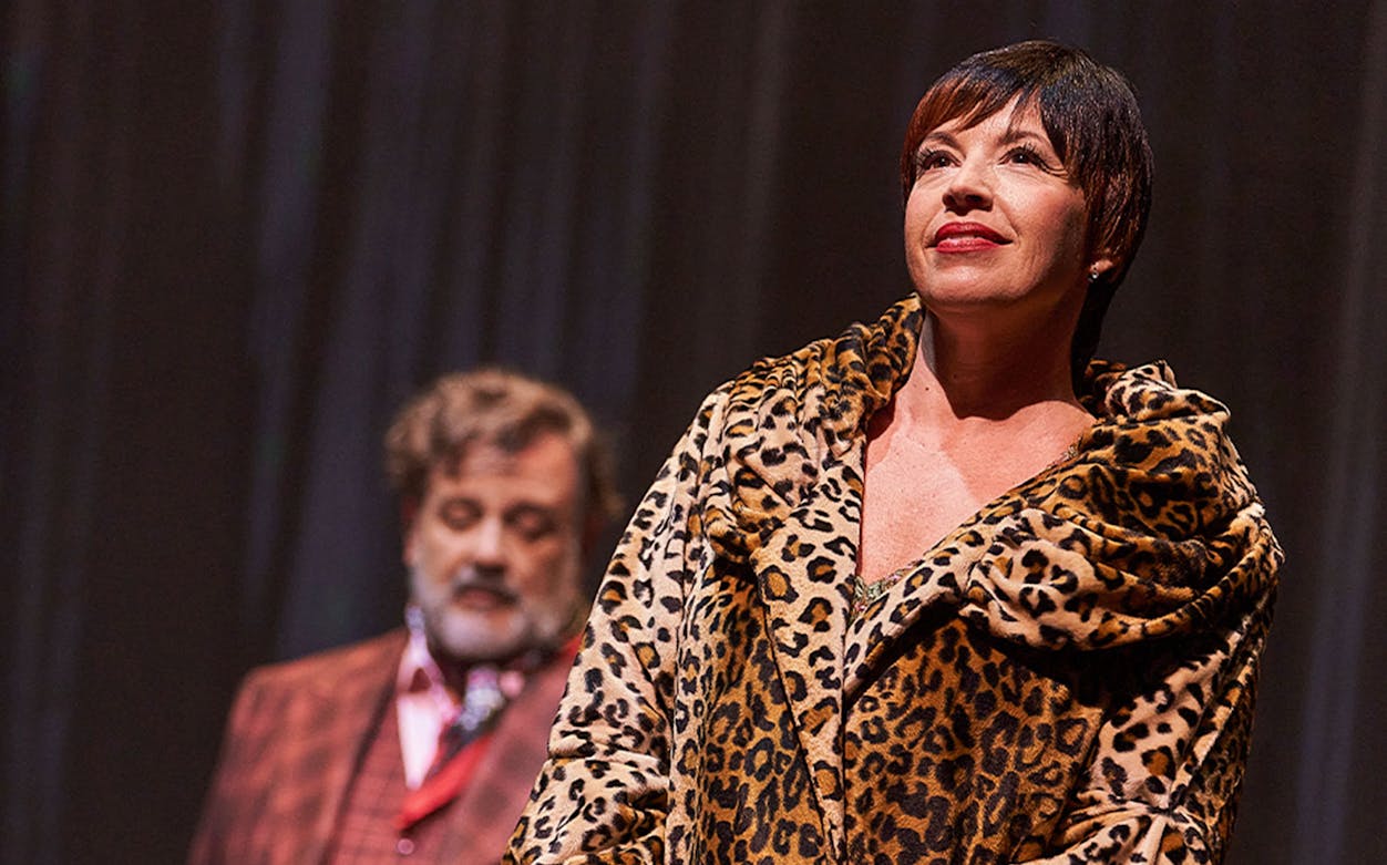 Performer in leopard print coat on stage during "Gypsy" musical.
